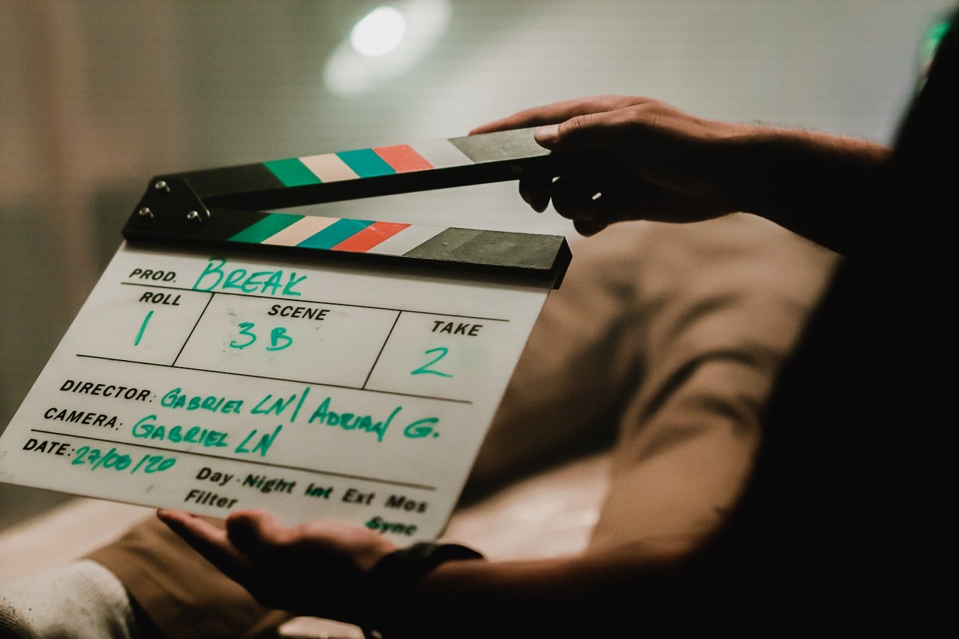 hand holding a clapper board on a video production